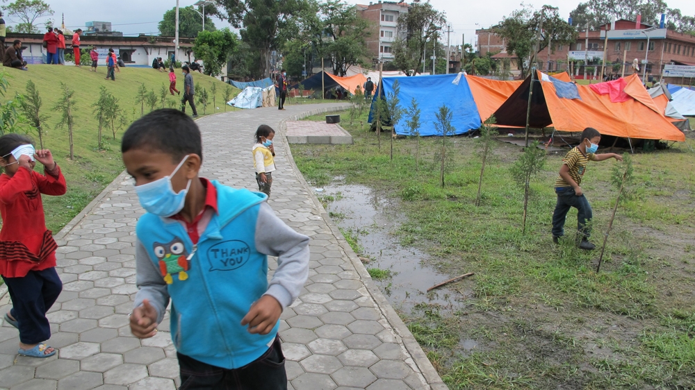 children playing in public park and temporary camp.