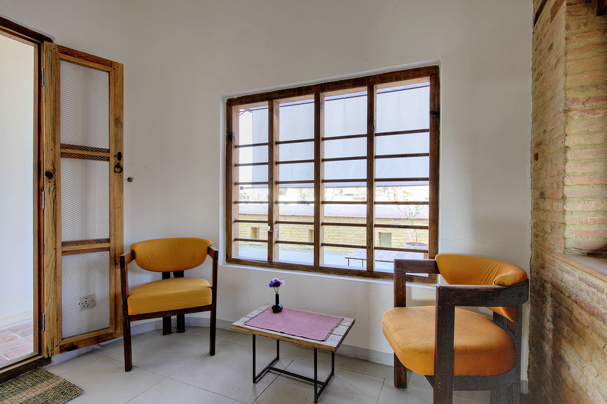 Simple modern indoor sitting area with open window